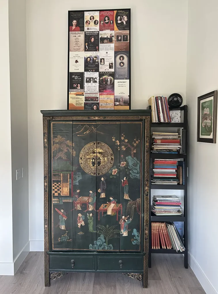 a handmade decorated cabinet displaying singing photos and accolades